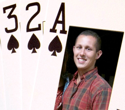 a man holding a card with a picture of him