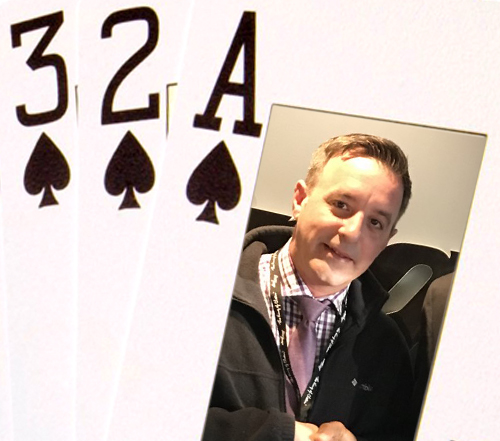 a man in a suit holding a pair of cards