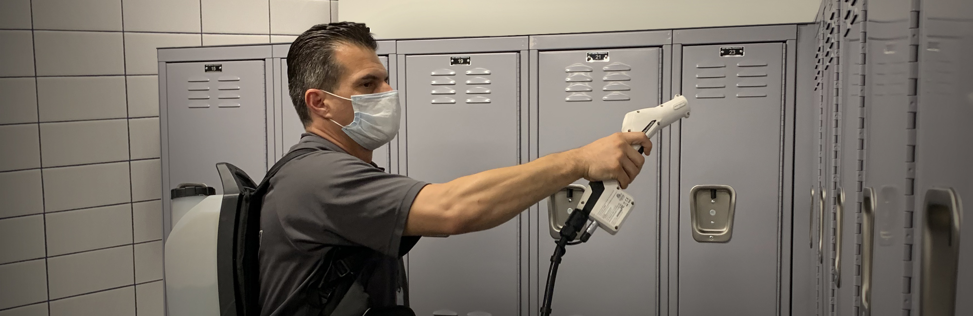 a man in a mask is putting a paper in a locker