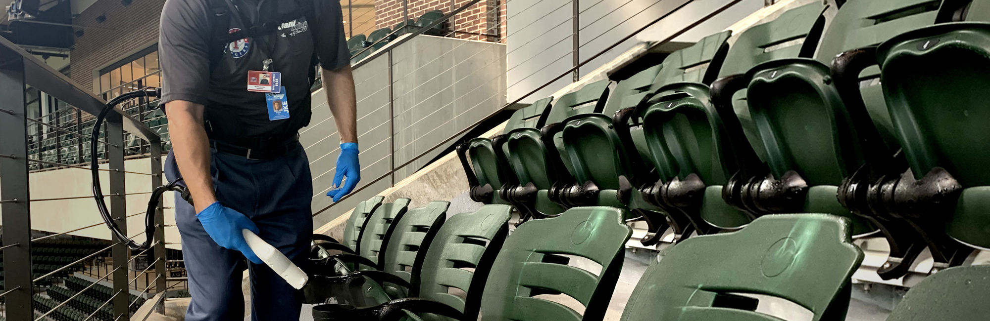 a man cleaning a baseball field with a mop