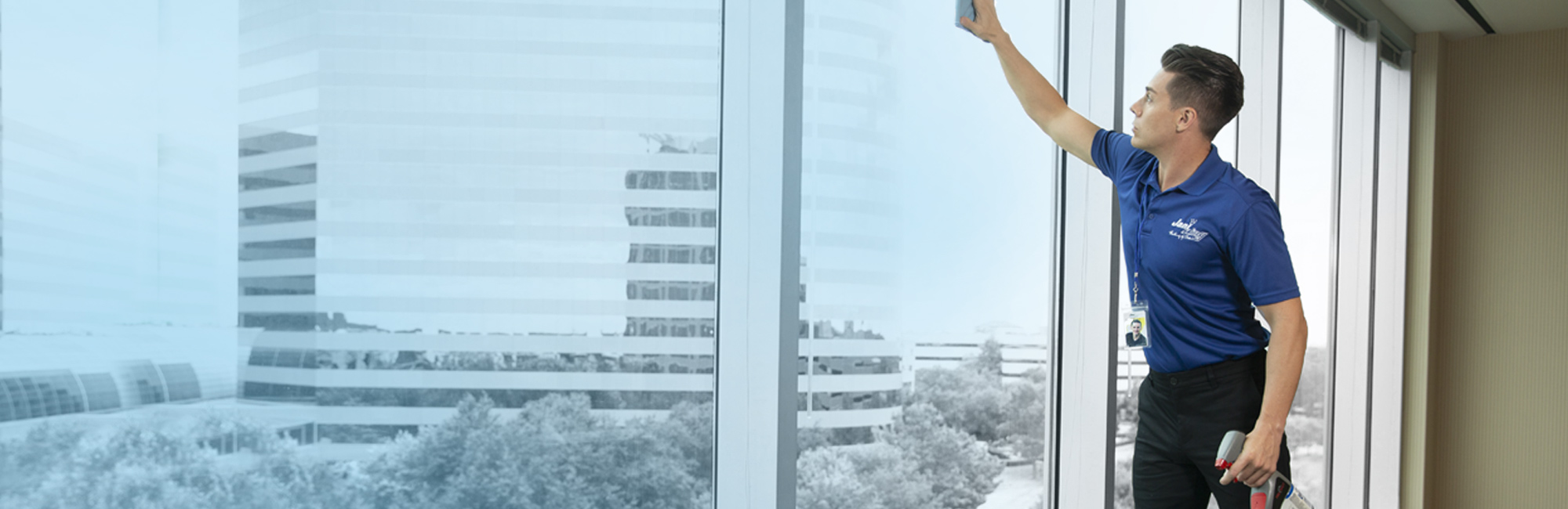 a cleaning employee cleaning windows