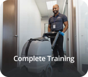 a man in a blue shirt and black pants is cleaning a room with a carpet cleaner