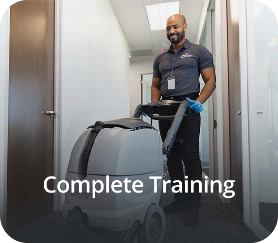 a man in a blue shirt and black pants is cleaning a room with a carpet cleaner