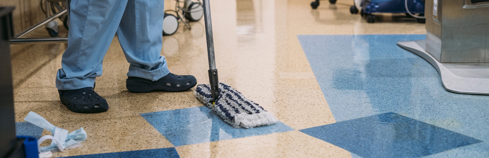 a man with a mop is cleaning the floor