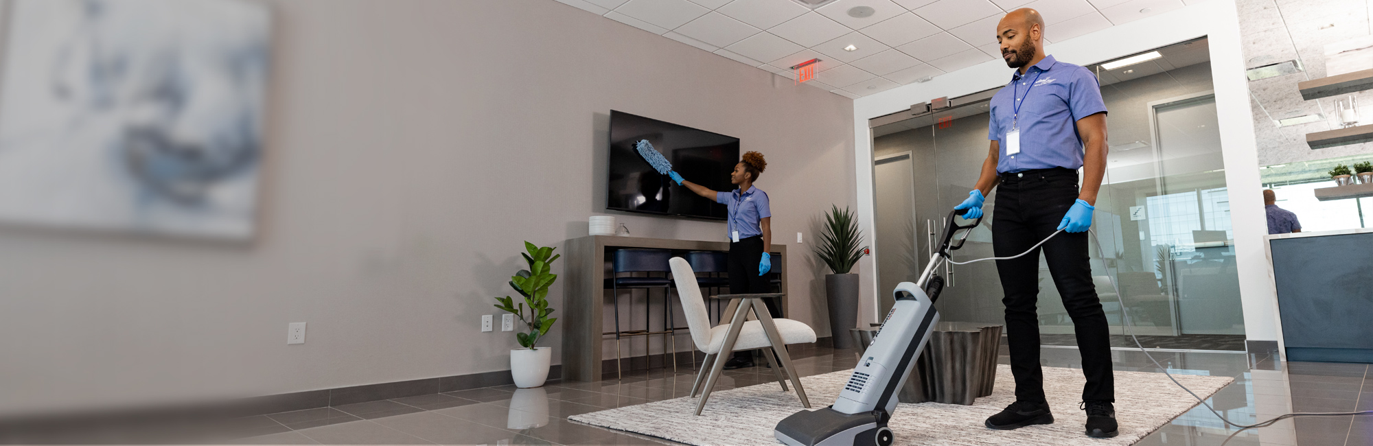 a man is cleaning a room with a vacuum