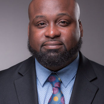 a man with a beard and a suit