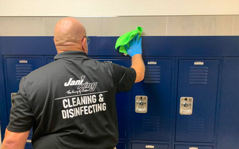 a man cleaning lockers in a locker