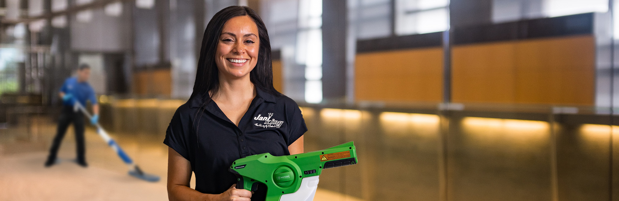 a woman holding a green blow gun