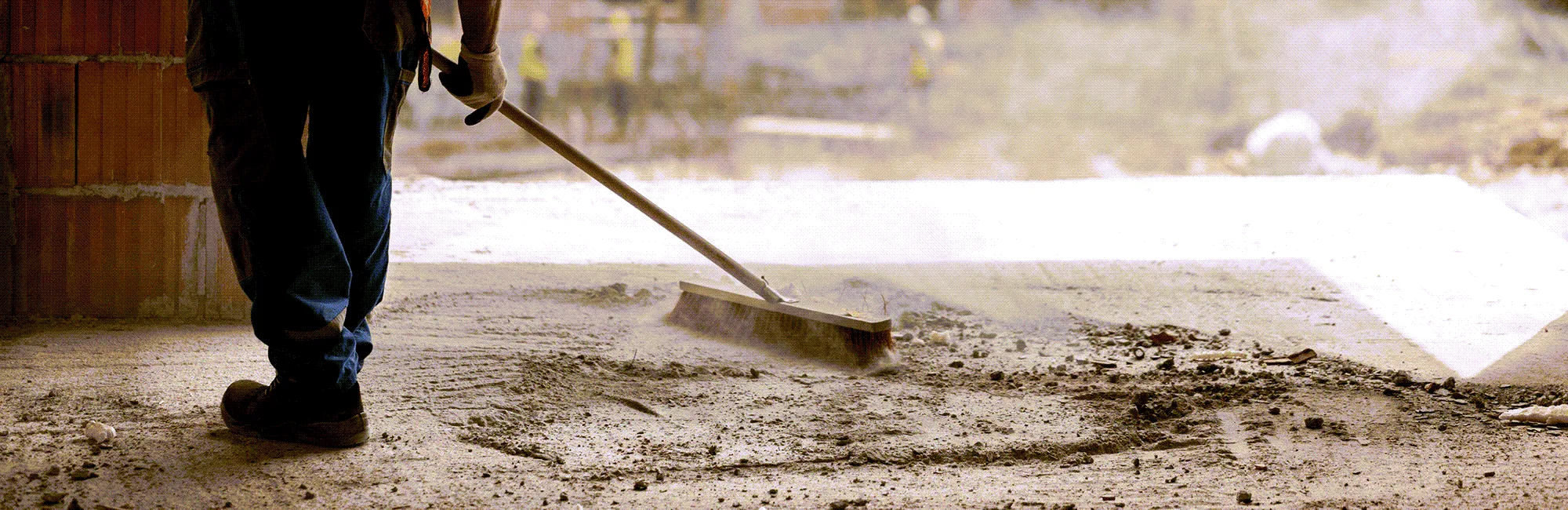 Post construction employee cleaning the area